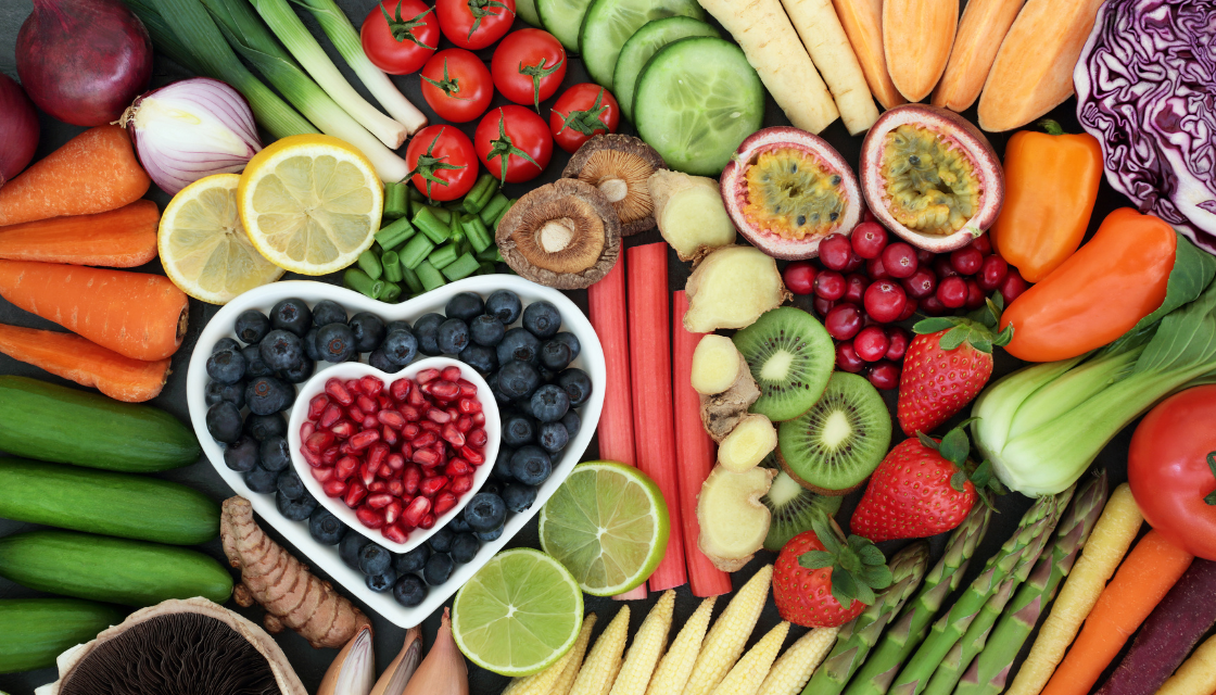 Frisches, buntes Obst und Gemüse in Herzform präsentiert praktische mentale Gesundheit Tipps für eine gehirnstärkende Ernährung. Die Vielfalt zeigt, wie Nährstoffe und natürliche Lebensmittel das mentale Gleichgewicht unterstützen.